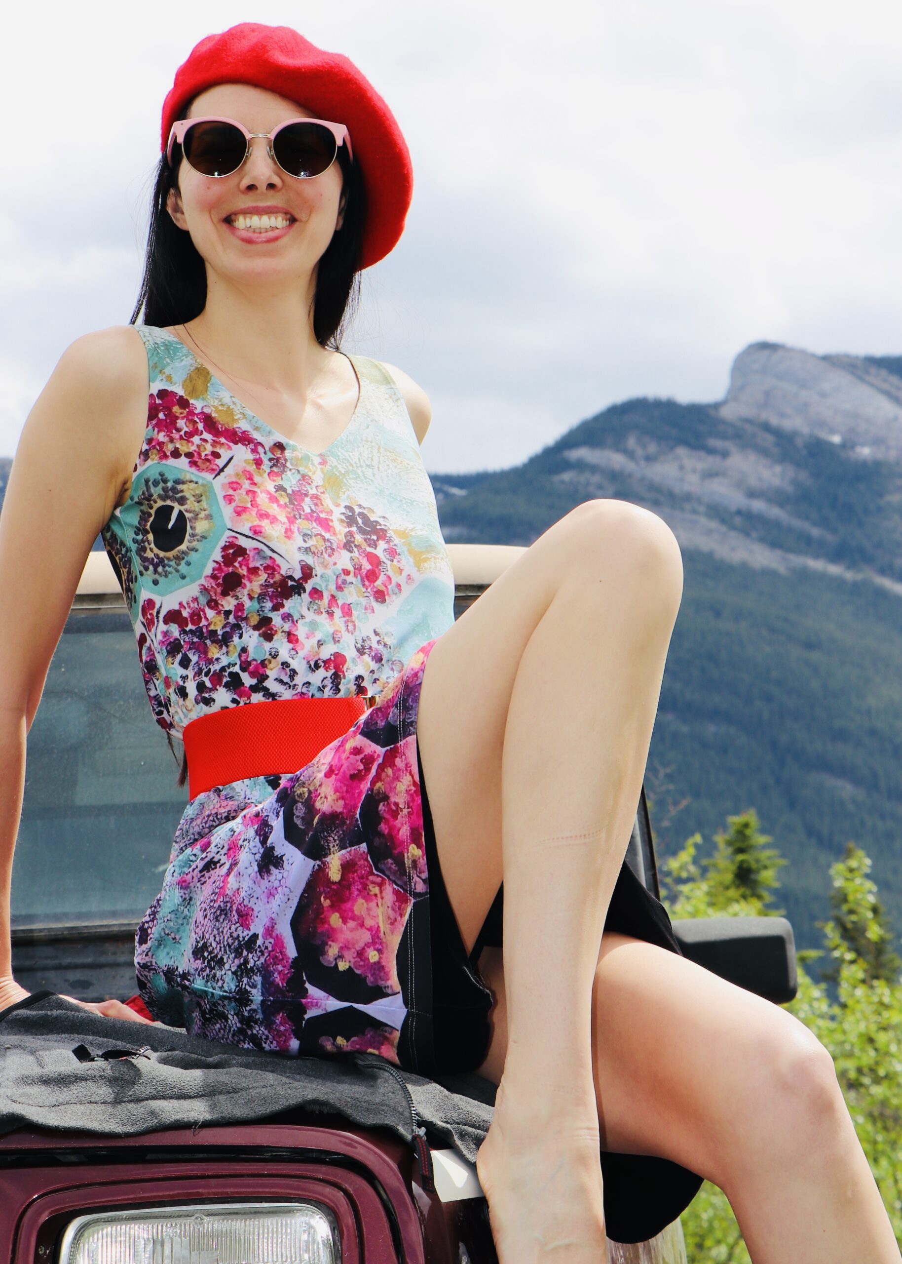 Portrait of autistic artist Layla Messner sitting on a vintageJeep, by Kelly's Perspective