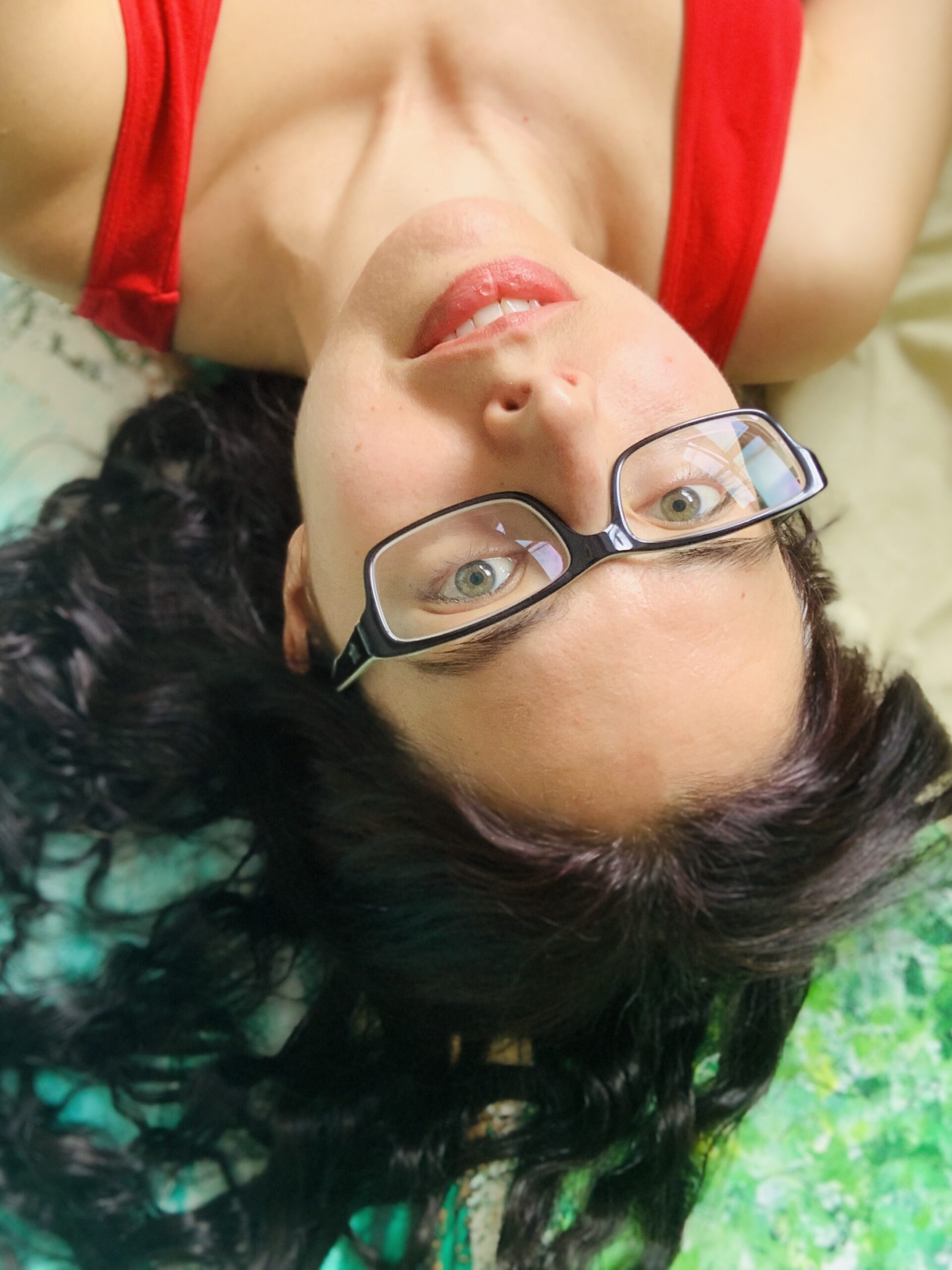 Autistic artist Layla Messner, upside down by a green painting